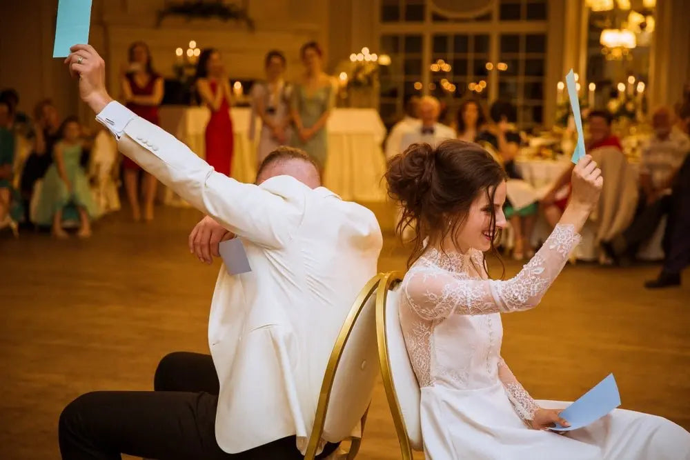 Bride and groom taking part in a Mr. & Mrs. quiz game at their wedding reception