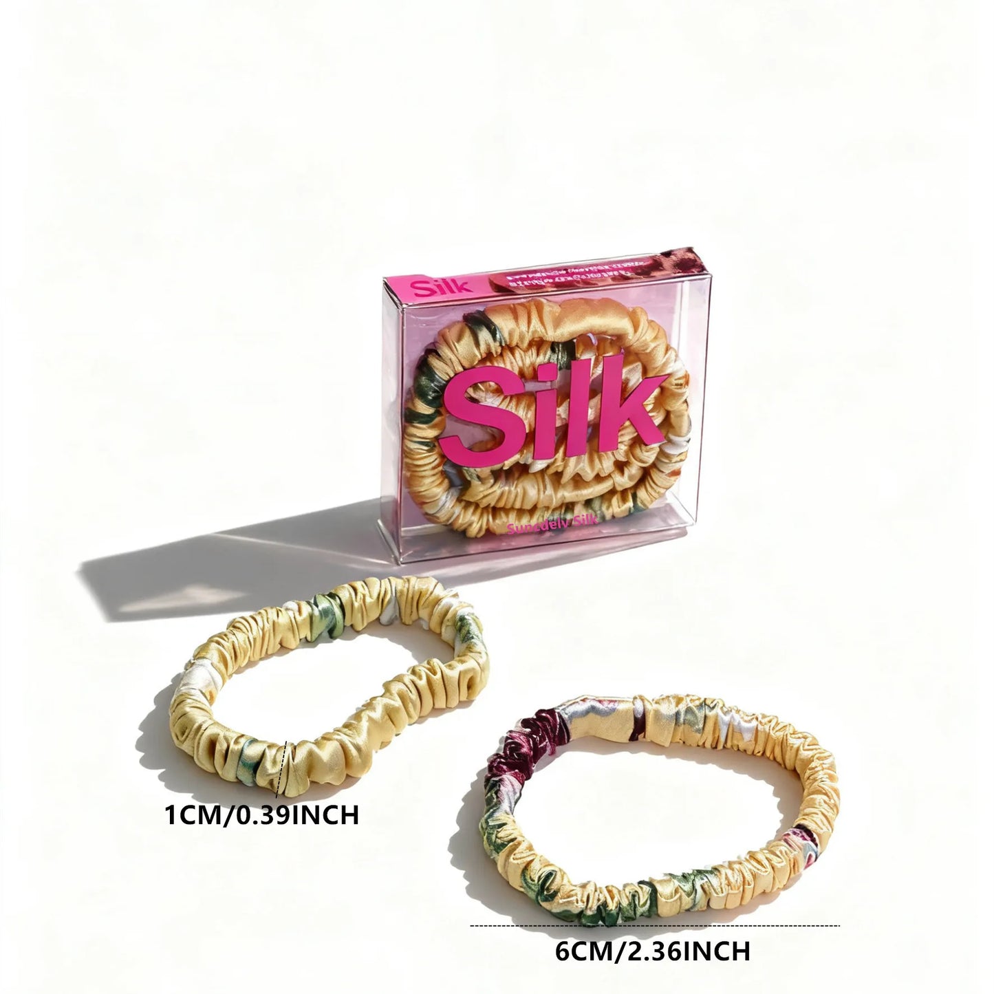 Silk hair ties with packaging on a white background