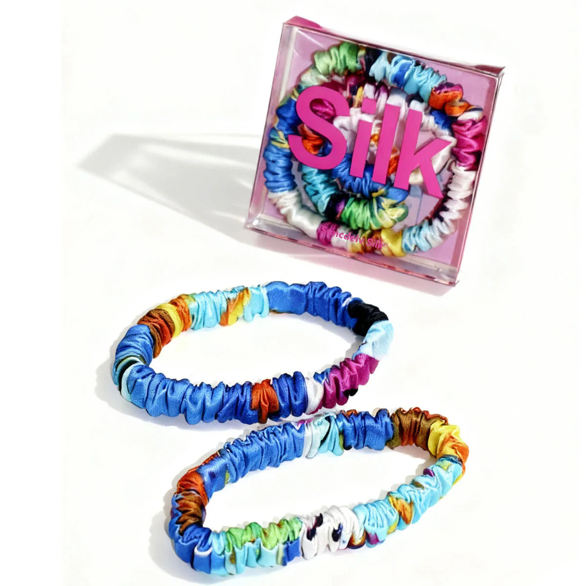 Colorful hair ties in a clear box with 'Silk' text on a white background