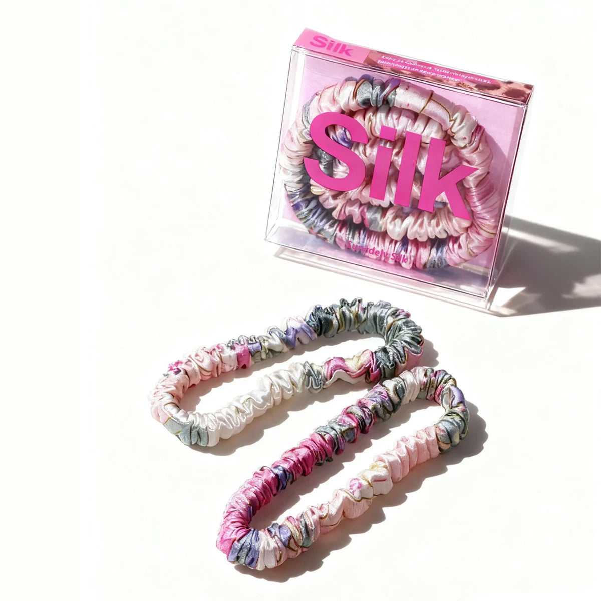 Colorful hair ties with packaging labeled 'Silk' on a white background