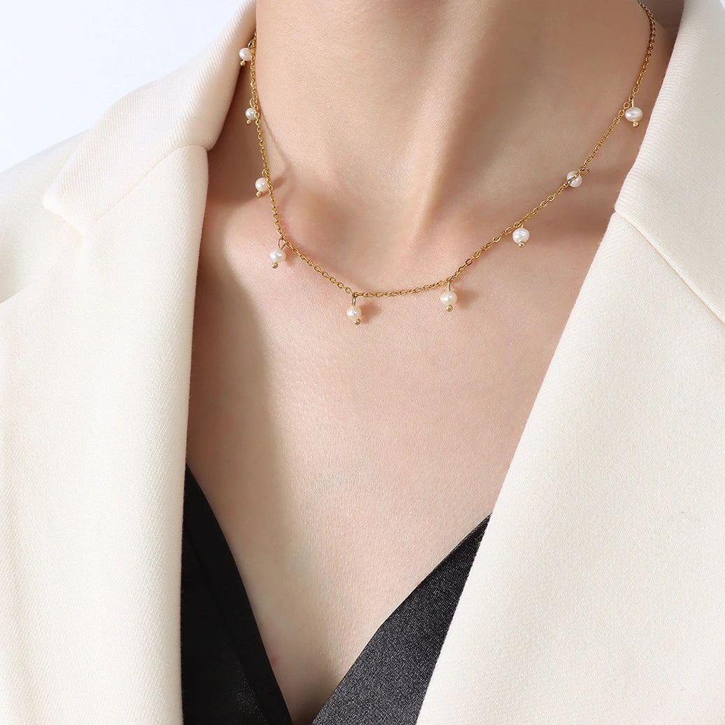 Pearl necklace on a person wearing a white blazer