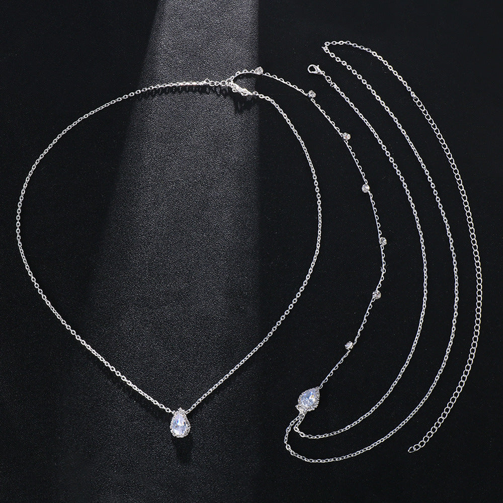 Silver necklace with a pendant on a black background