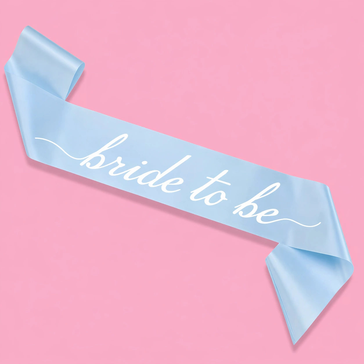 Light blue sash with 'bride to be' text on a pink background