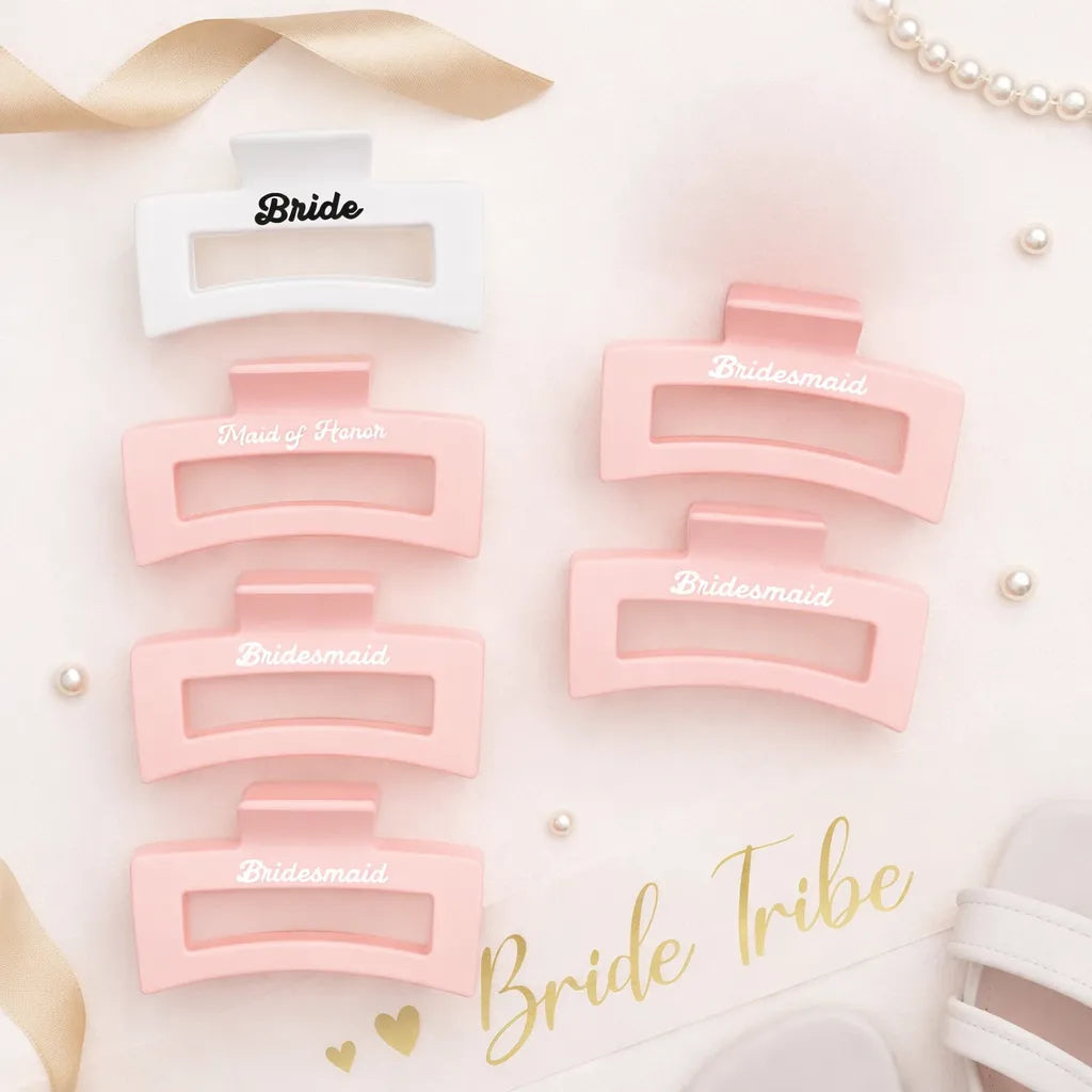 Bridal party hair claw clips in blush pink and white with Bride, Bridesmaid and Maid of Honour text on a soft bridal flat lay.