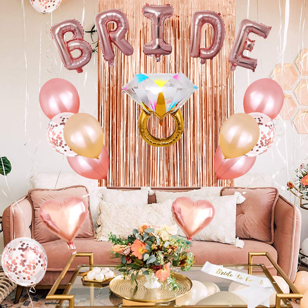 Decorated living room with 'BRIDE' balloons and a diamond ring balloon, indicating a bridal shower.
