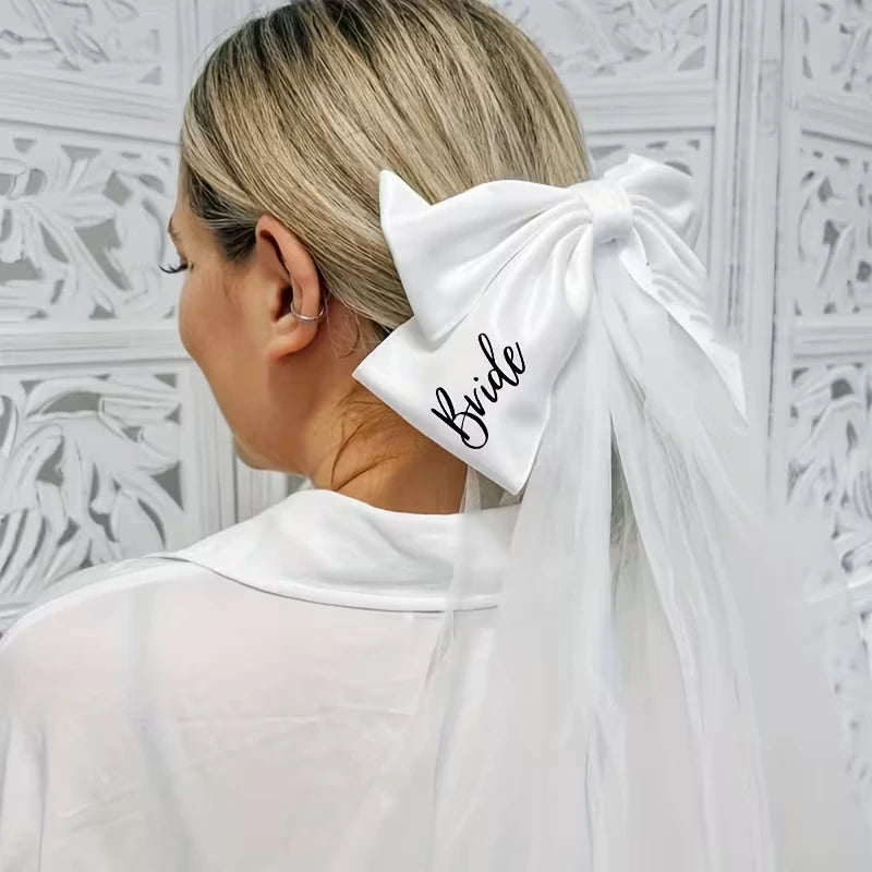 Woman with a white bow in her hair labeled 'Bride' against a white decorative wall.