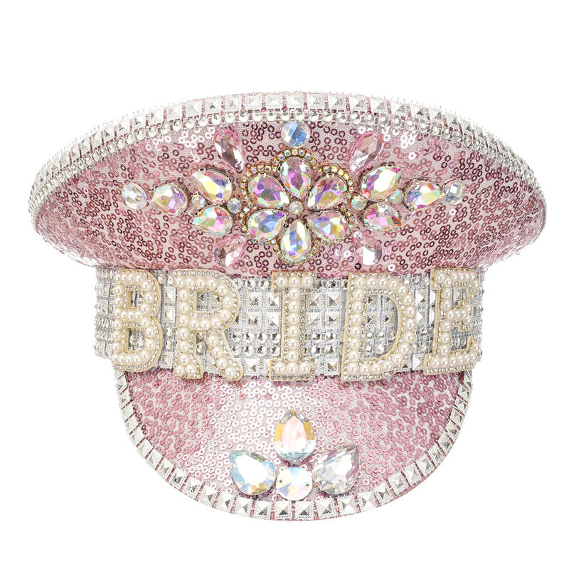 Pink cap with 'BRIDE' and rhinestone embellishments on a white background