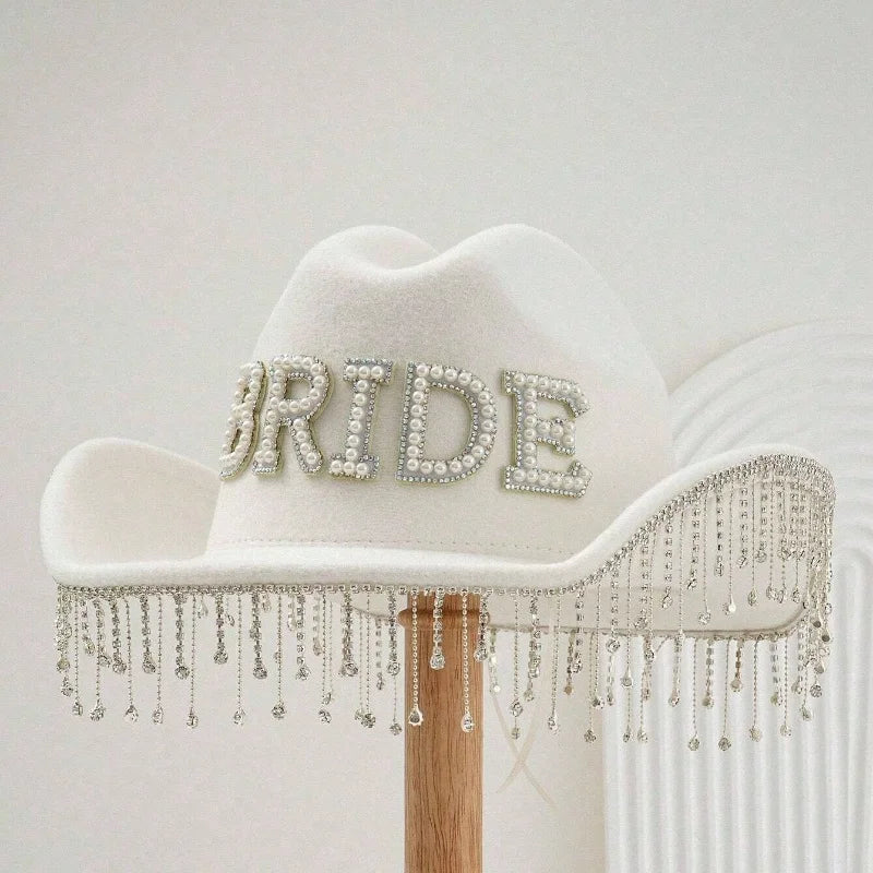 White cowboy hat with 'BRIDE' embellishments on a white background