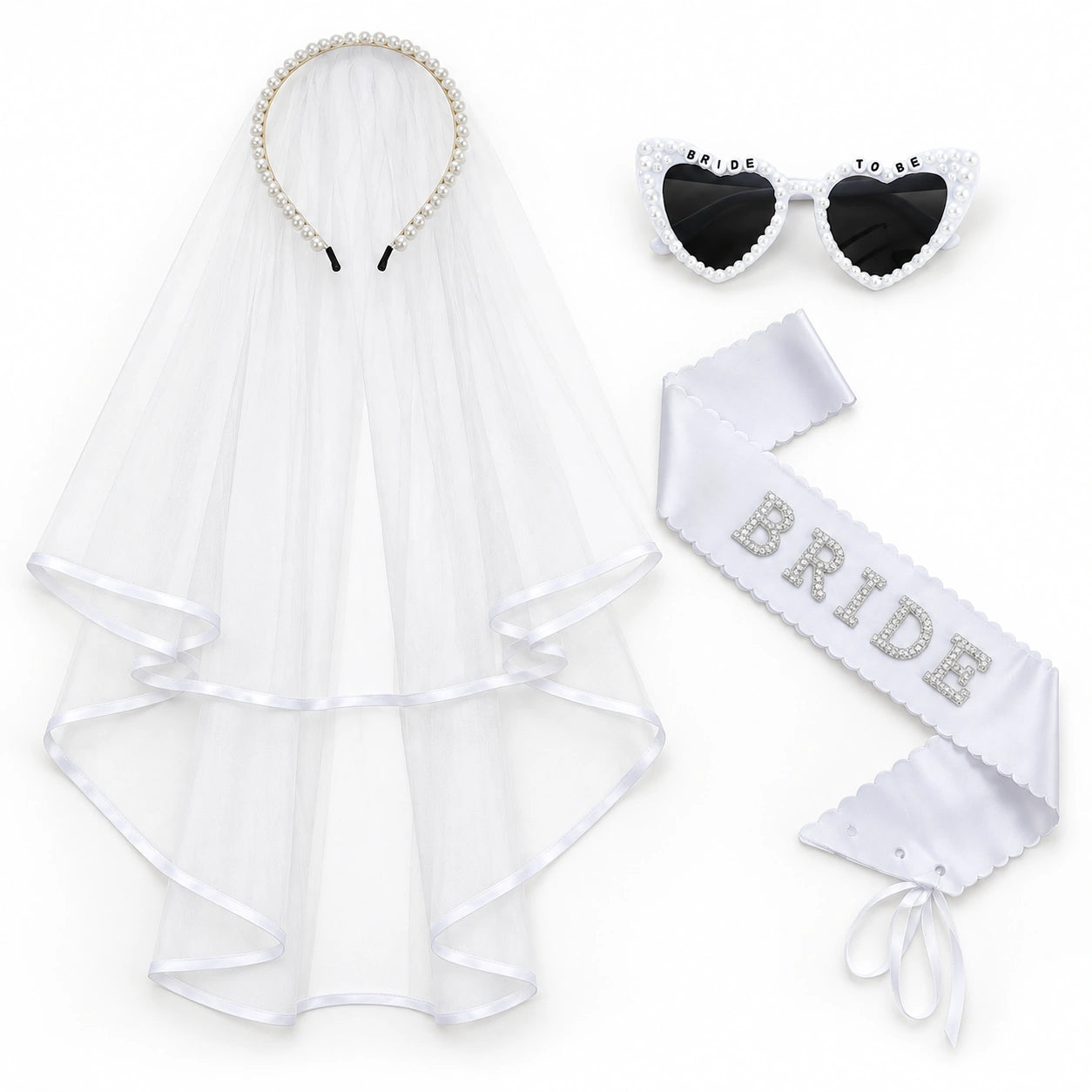 Bride set on a white background, including a white tulle veil with pearl-trimmed headband, heart-shaped sunglasses with 'BRIDE TO BE' text, and a white satin sash with 'BRIDE' in rhinestones.