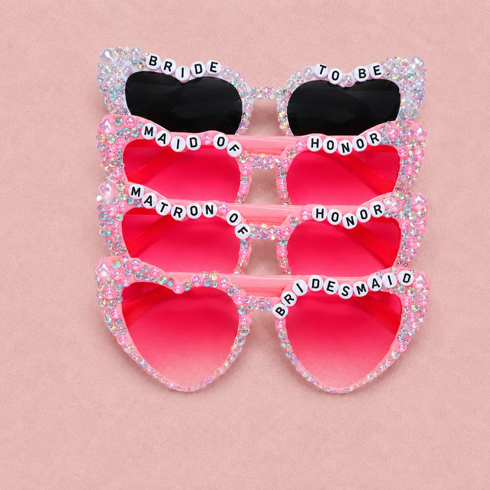 Sunglasses with decorative text on a pink background