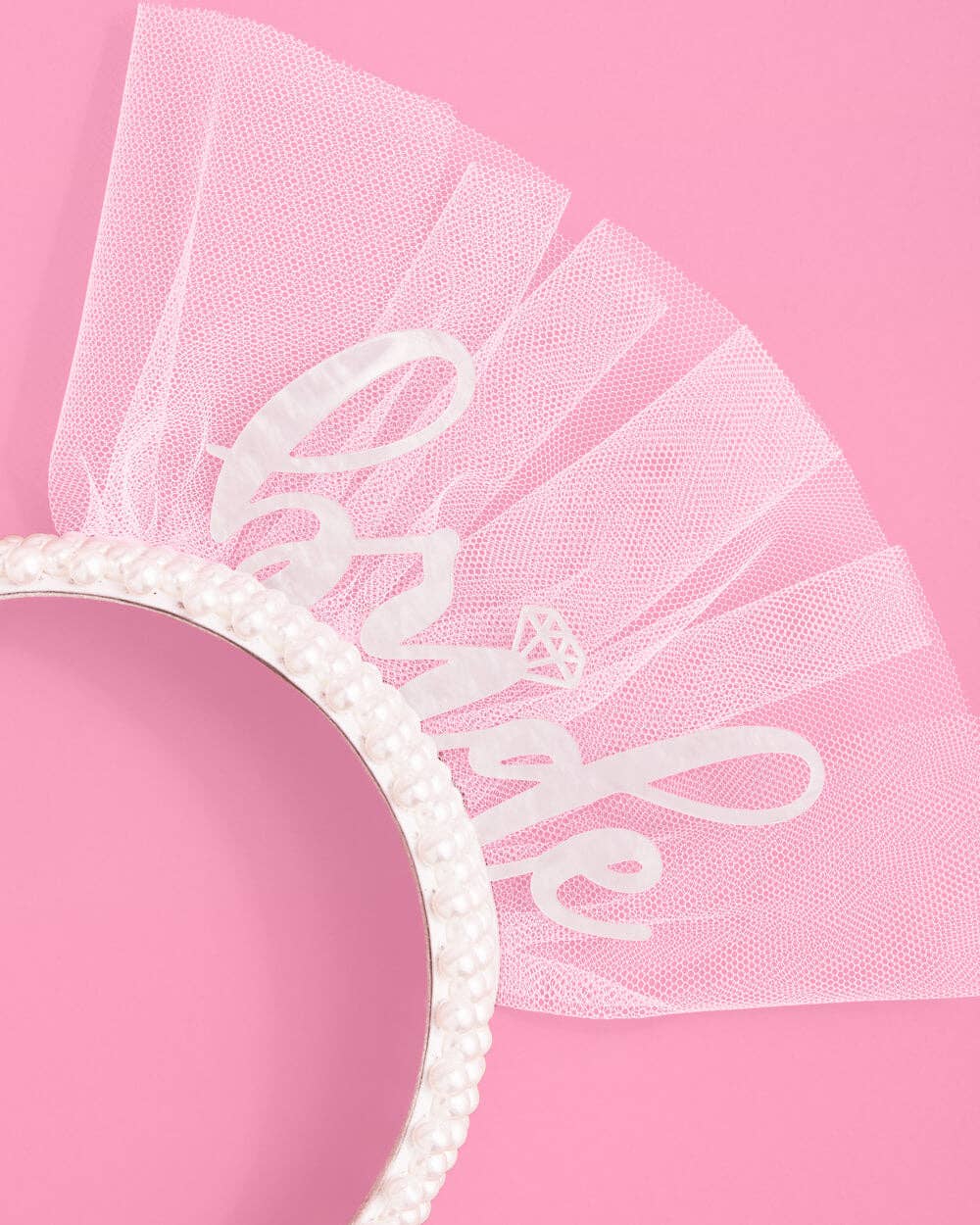 White veil with 'bride' and pearl design on a pink background