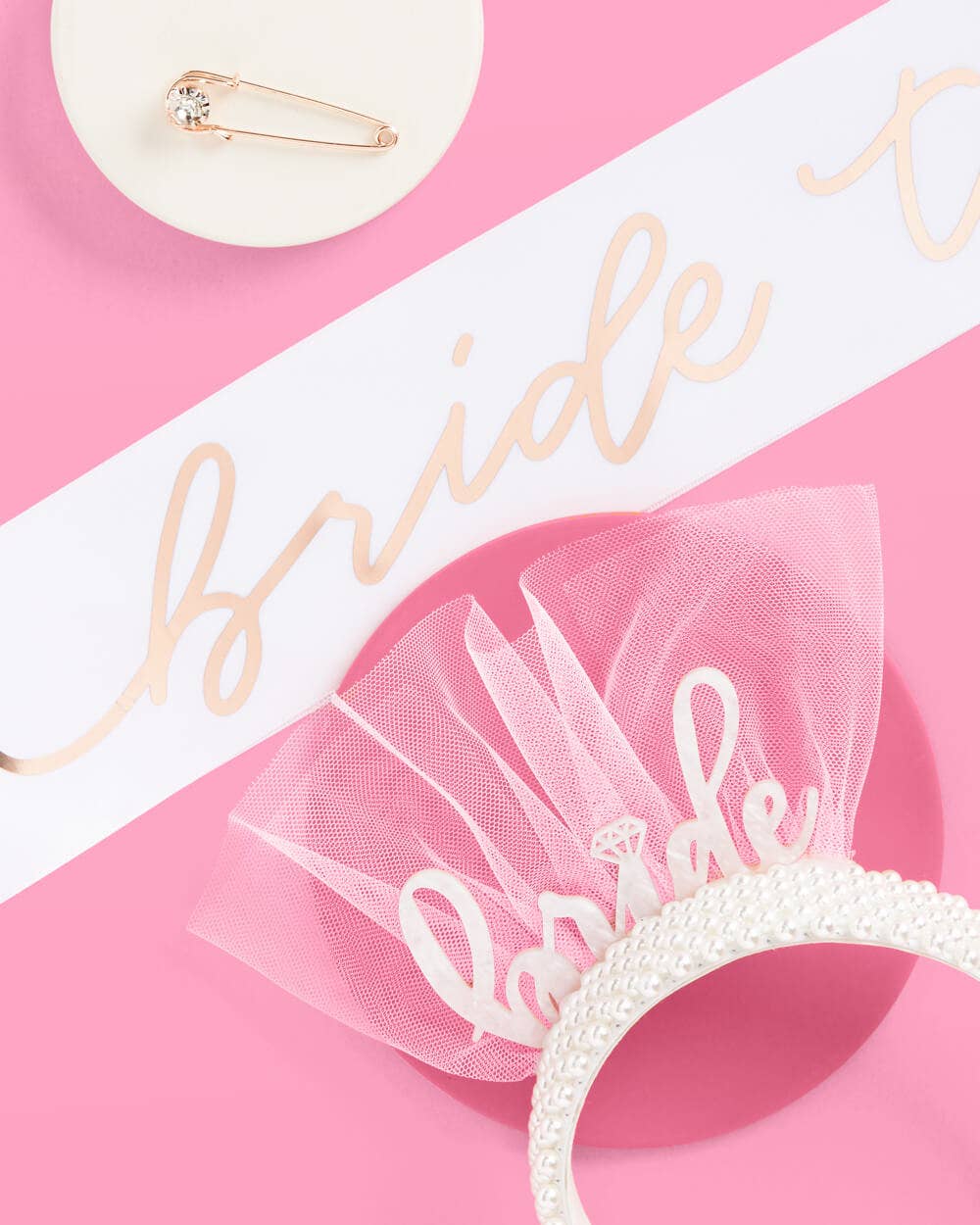 Bride to be sash with veil and headband on a pink and white background
