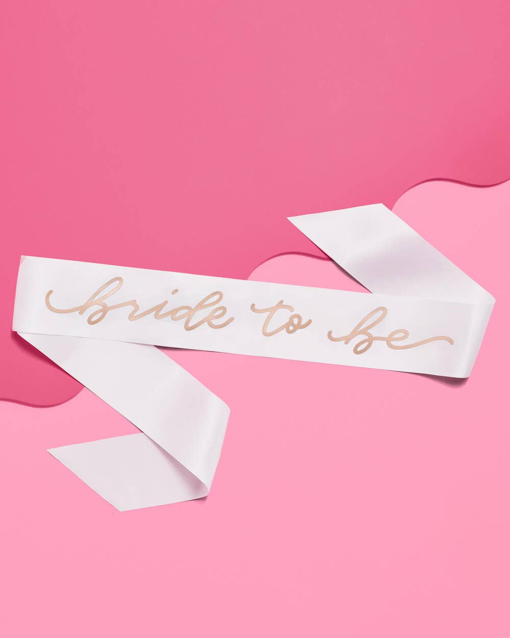 White sash with 'Bride to be' text on a pink background