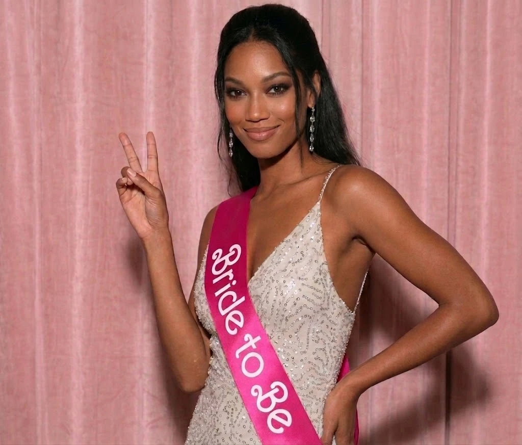 Woman wearing a 'Bride to Be' sash against a pink background
