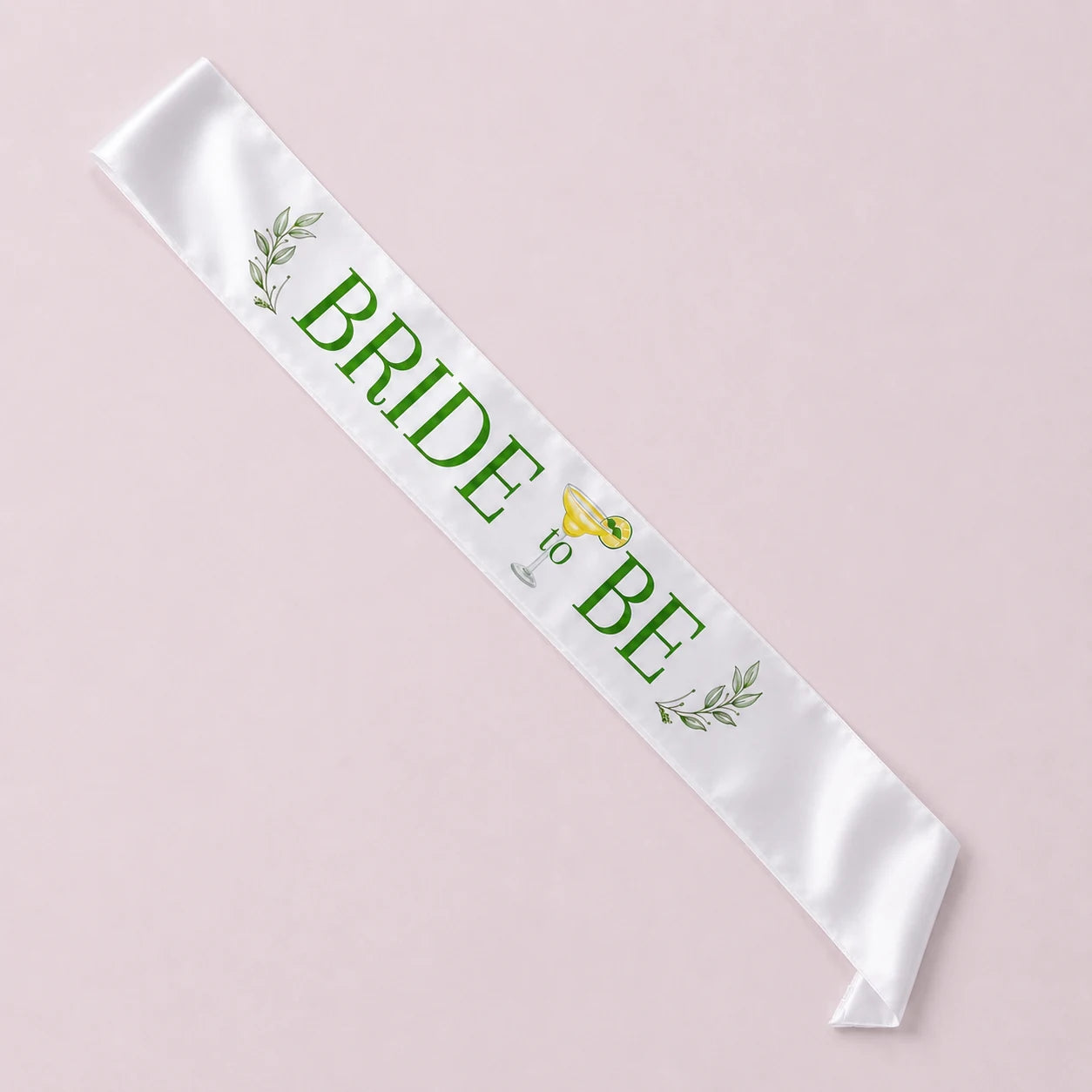 White sash with 'Bride to Be' text and decorative elements on a light pink background