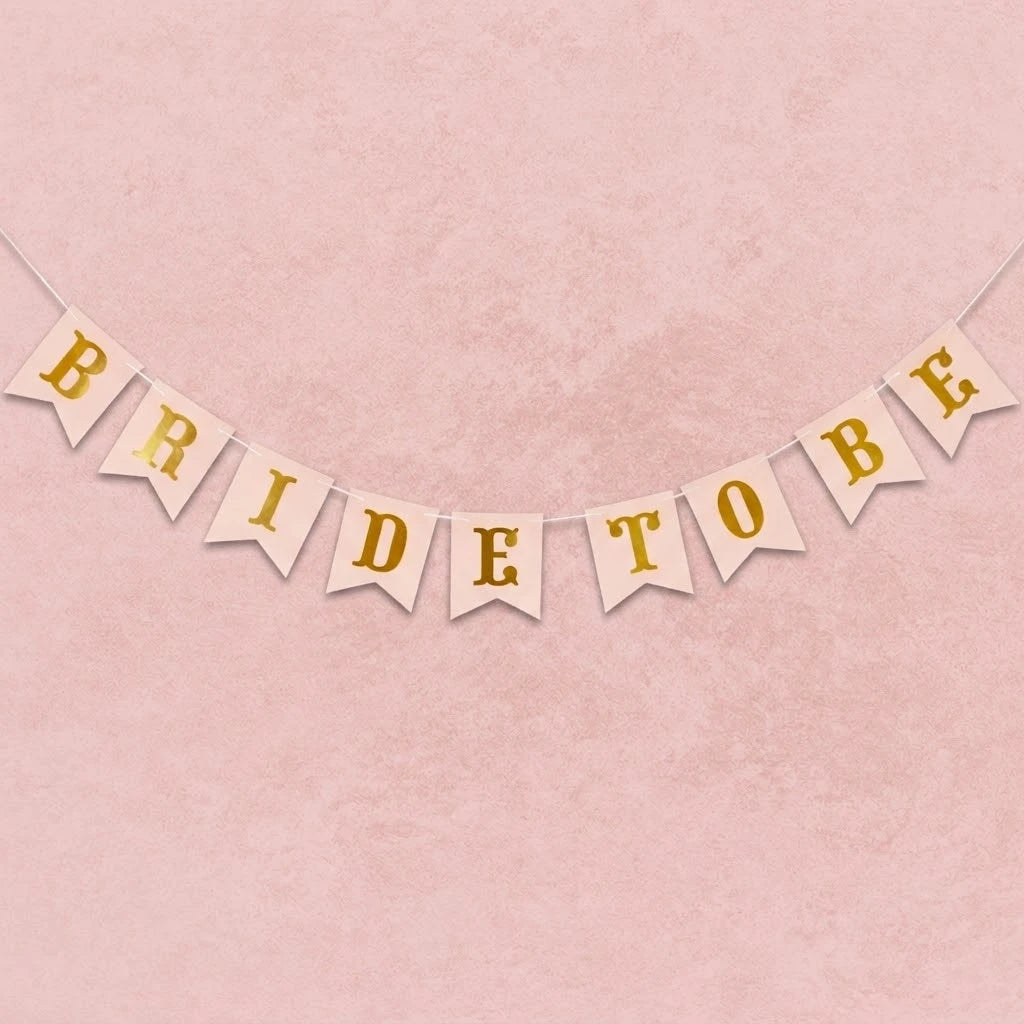 Bride to be banner with gold text on a pink background