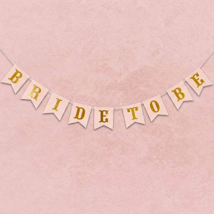 Bride to be banner with gold text on a pink background