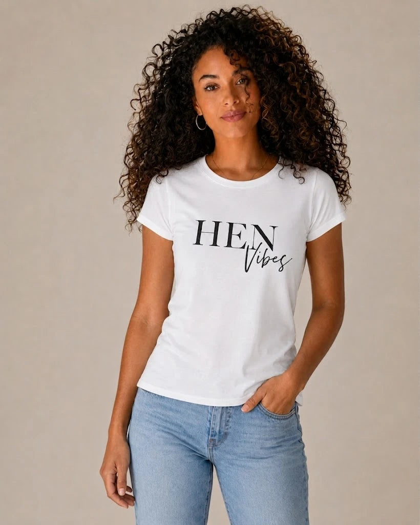 Woman wearing a white t-shirt with 'HEN Vibes' text on a beige background