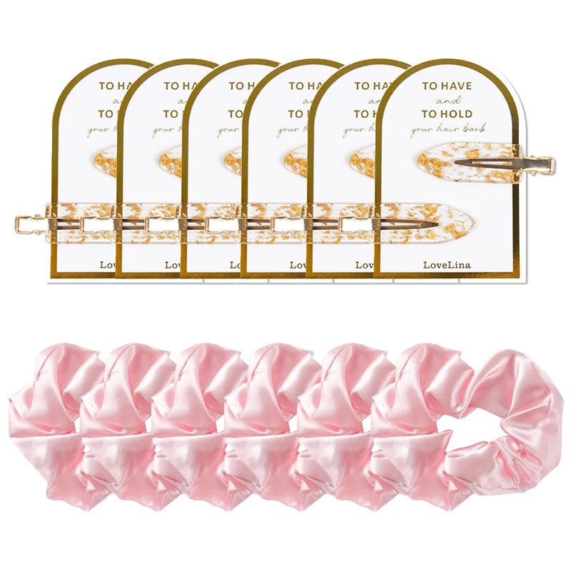 Set of gold hair clips and a pink scrunchie with Lovelina packaging on a white background.