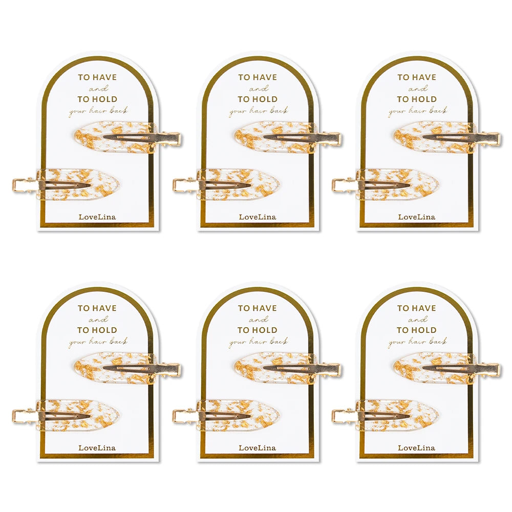 Set of six hair clips on cards with 'To Have and To Hold your hair back' branding on a white background