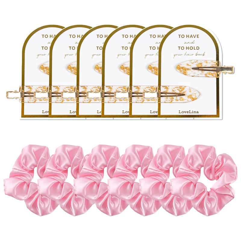 Set of pink scrunchies with gold hair clips on a white background