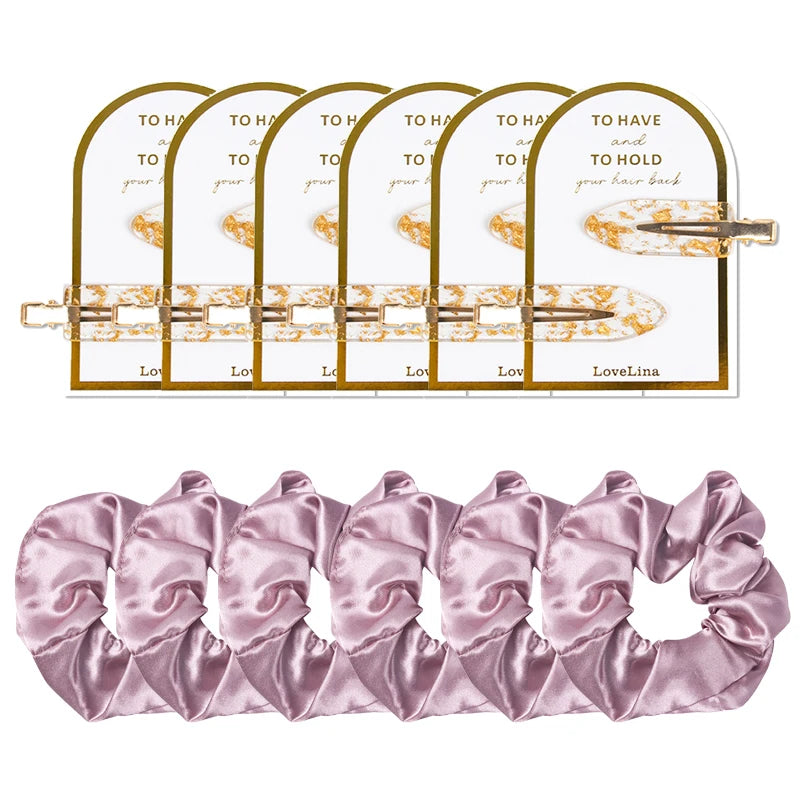 Set of lilac hair accessories for bridesmaids including clips and a scrunchie on a white background
