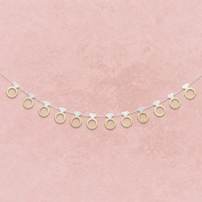 Decorative banner with gold rings on a pink background