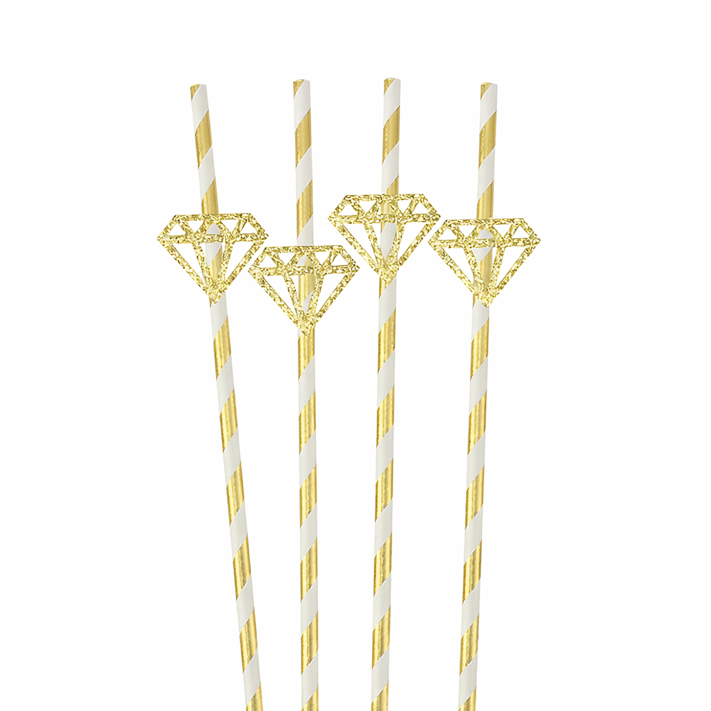 Gold and white straws with diamond designs on a white background