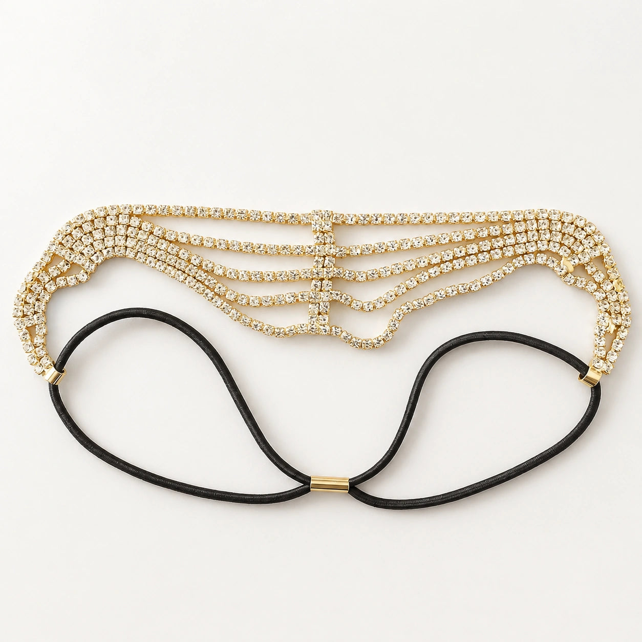 Gold beaded headband with black hair ties on a white background