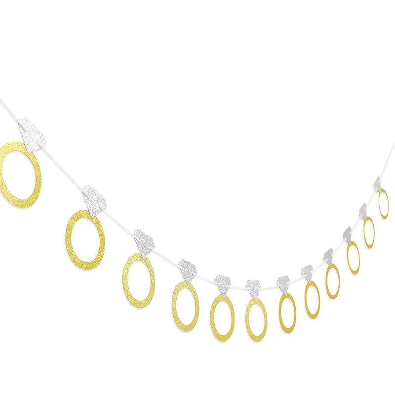 Decorative banner with gold rings and white accents on a white background
