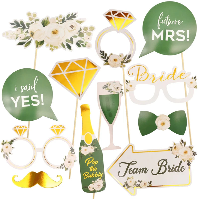 Collection of bridal shower photo booth props including rings, champagne glasses, and speech bubbles on sticks.