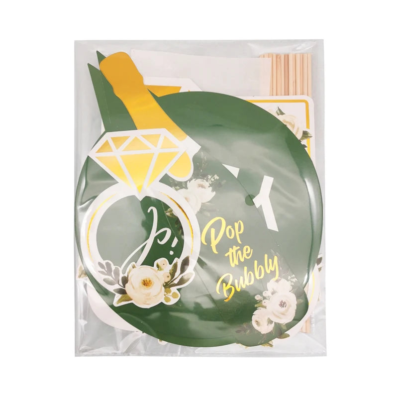 Balloon with 'Pop the Bubbly' text and floral design, featuring a yellow pencil and green leaf.