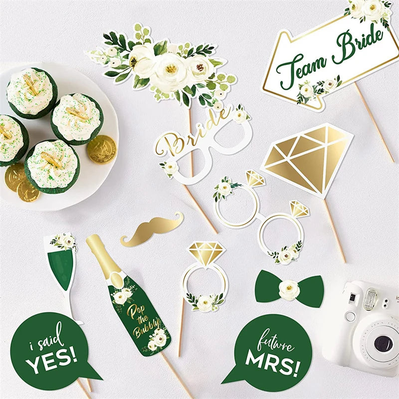 Collection of green and gold party decorations including signs and cupcake toppers on a white background.