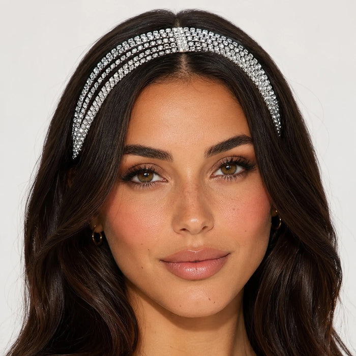 Woman wearing a decorative headband with a plain background