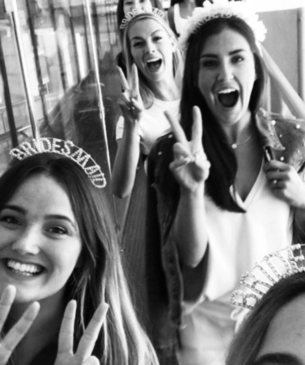 Bride squad celebrating at a hen party wearing bridal headbands and veil accessories