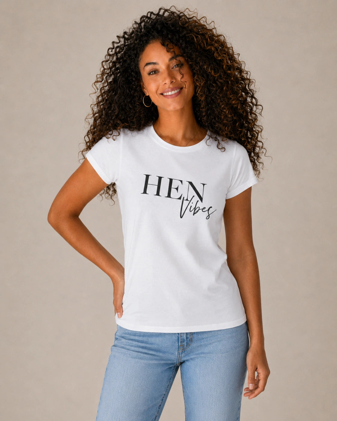 Woman wearing a white t-shirt with 'HEN Vibes' text on a beige background