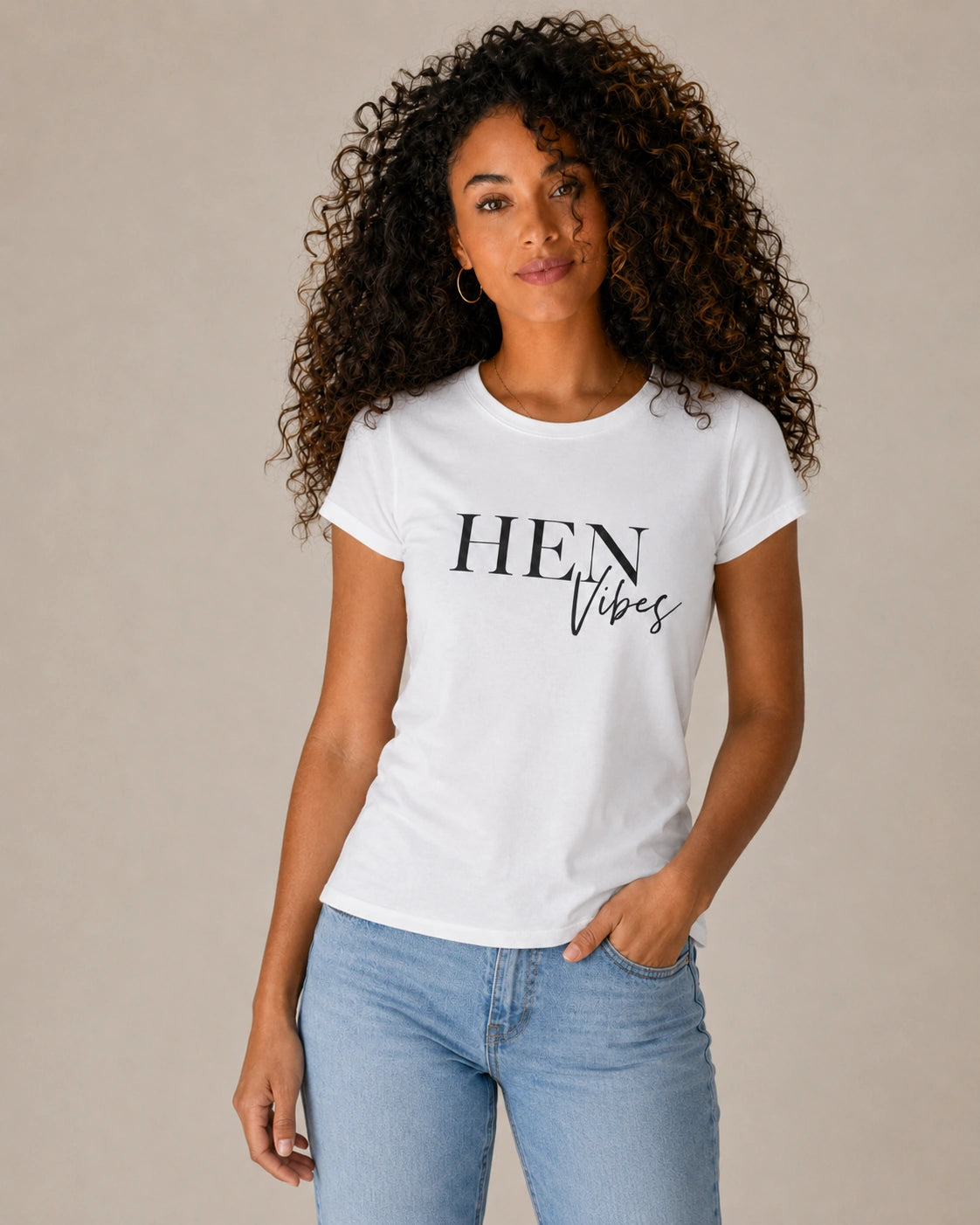 Woman wearing a white t-shirt with 'HEN Vibes' text on a beige background