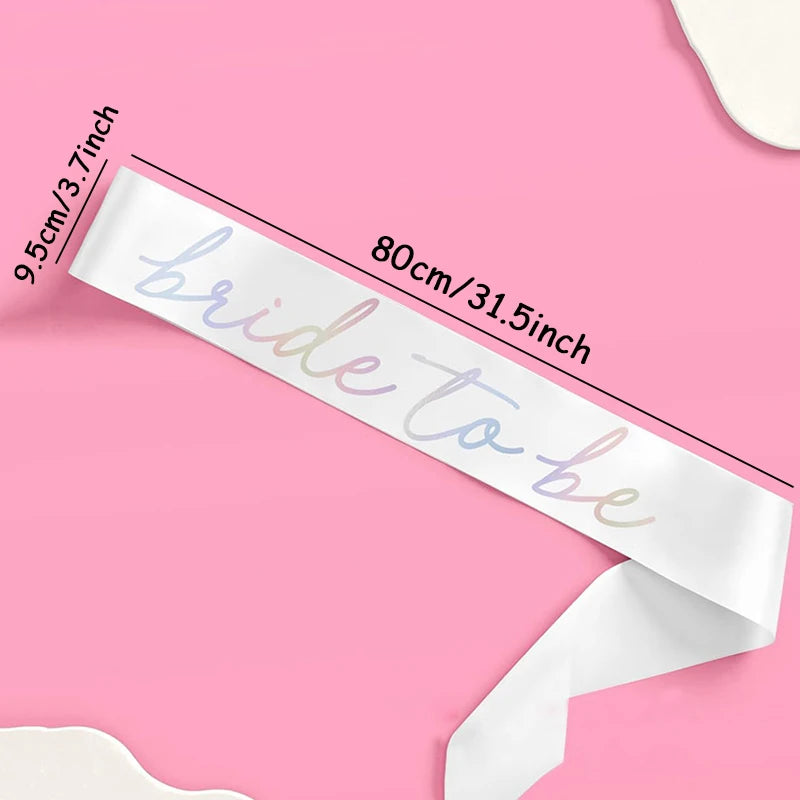 White sash with 'bride to be' iridescent text on a pink background