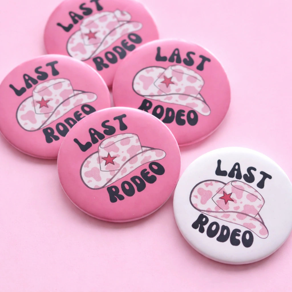 Pink and white buttons with cowboy hats and 'Last Rodeo' text on a pink background