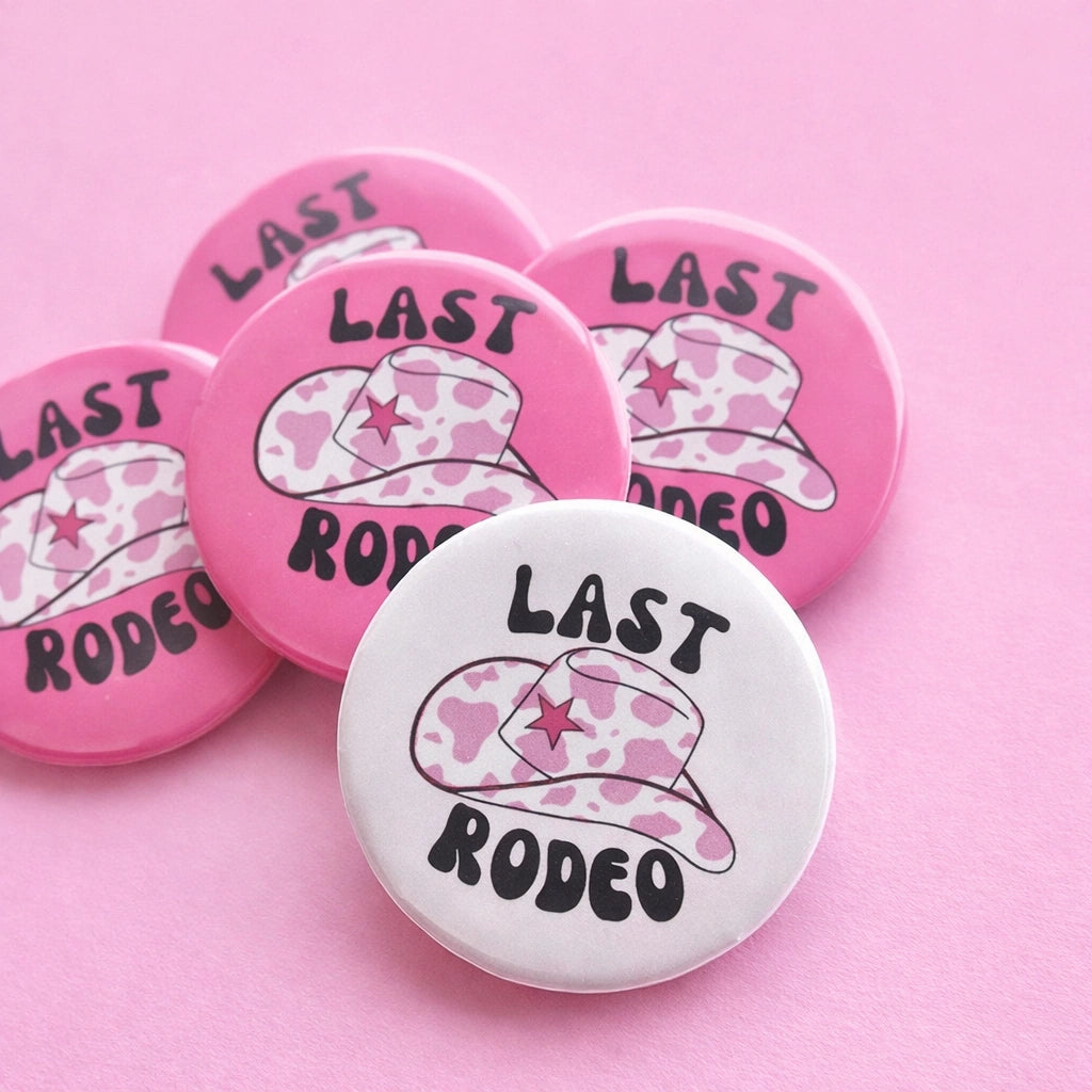 Buttons with 'Last Rodeo' design on a pink background