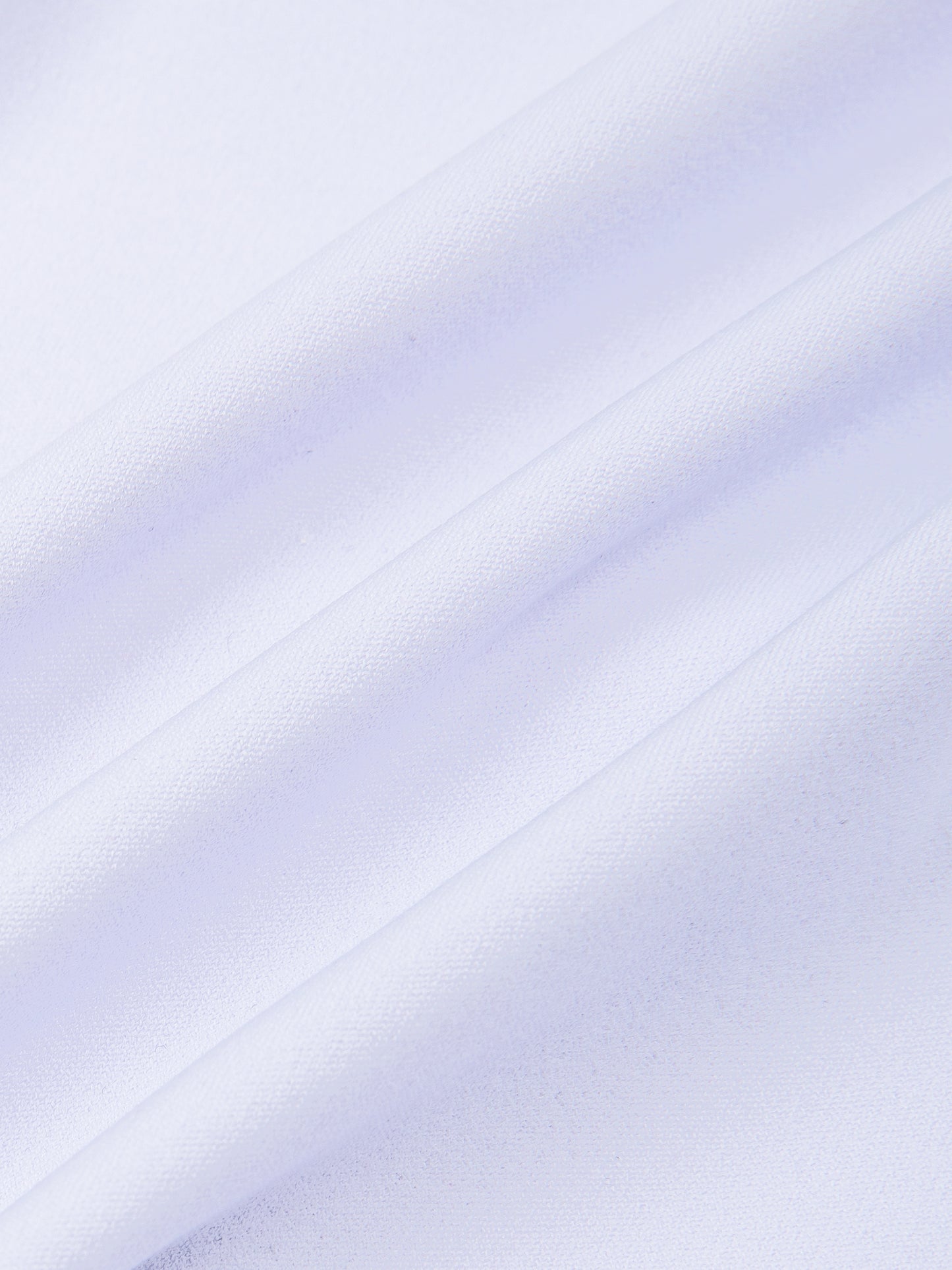 A close-up of a light lavender or pale purple fabric with soft diagonal folds and a smooth texture.