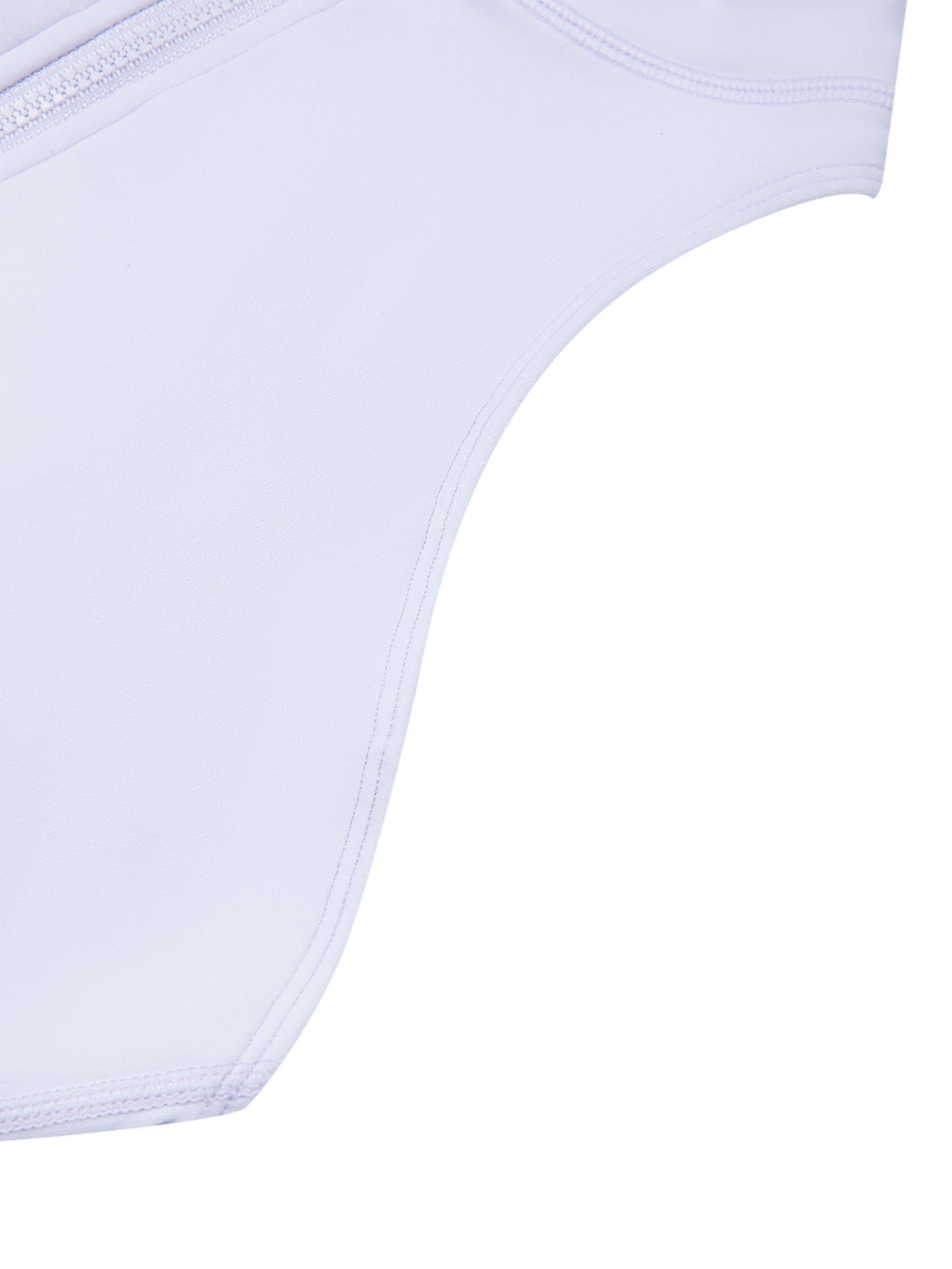 A close-up detail shot of a lilac romper, showing a curved seam and a zipper along the top edge against a solid white background.