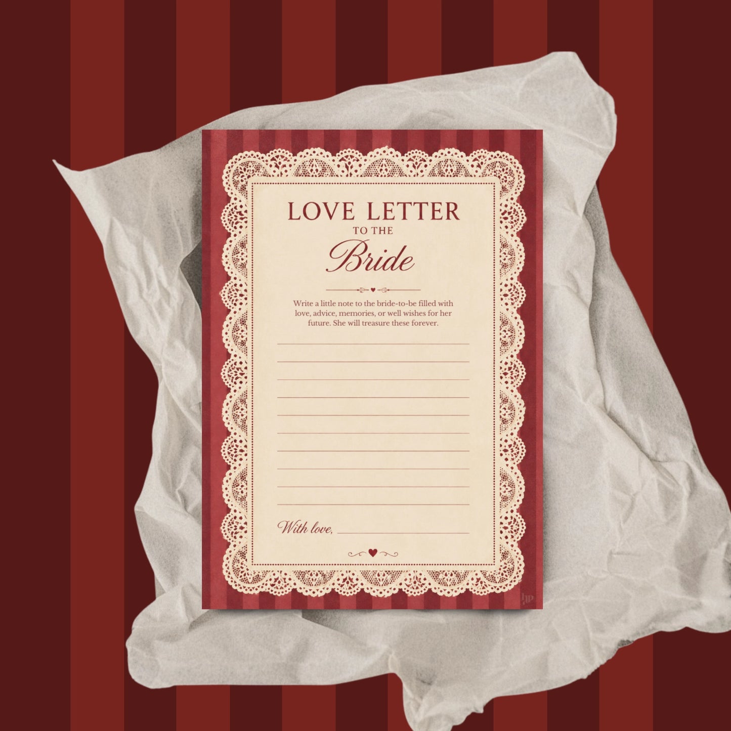 A red and cream 'Love Letter to the Bride' writing card, styled on top of crumpled white tissue paper against a dark red and gold striped background.