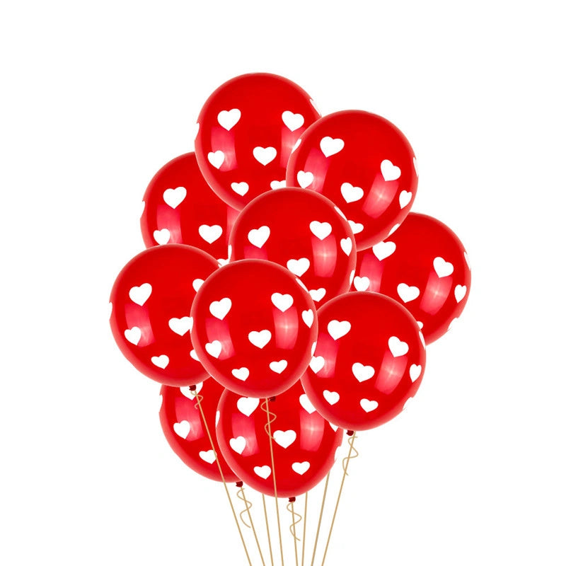 Red balloons with white heart patterns on a white background