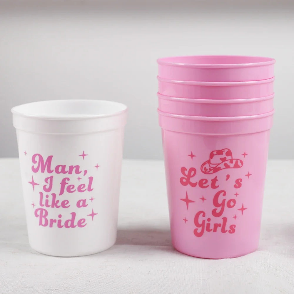 White cup with pink text and pink cups with similar text on a white background