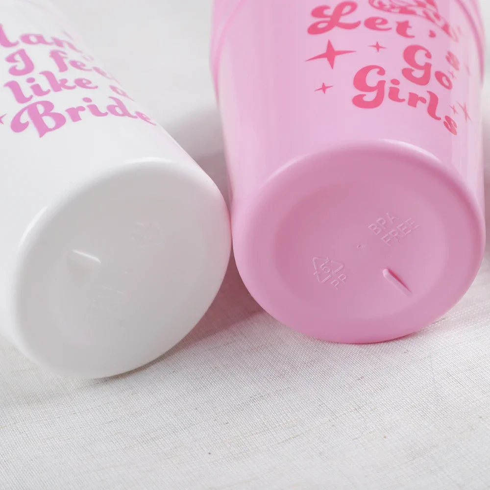 Two cylindrical containers with pink text on a white background