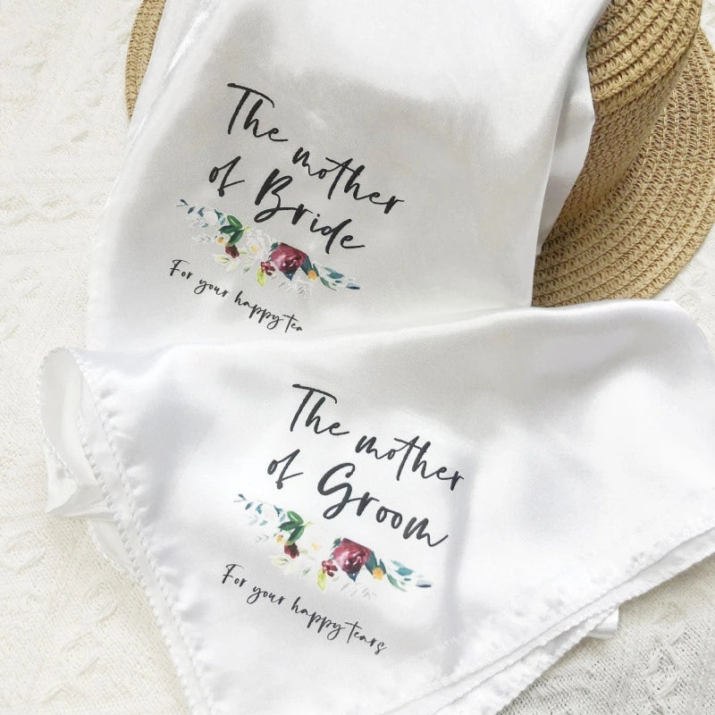 Two white handkerchiefs with floral designs and text on a light background