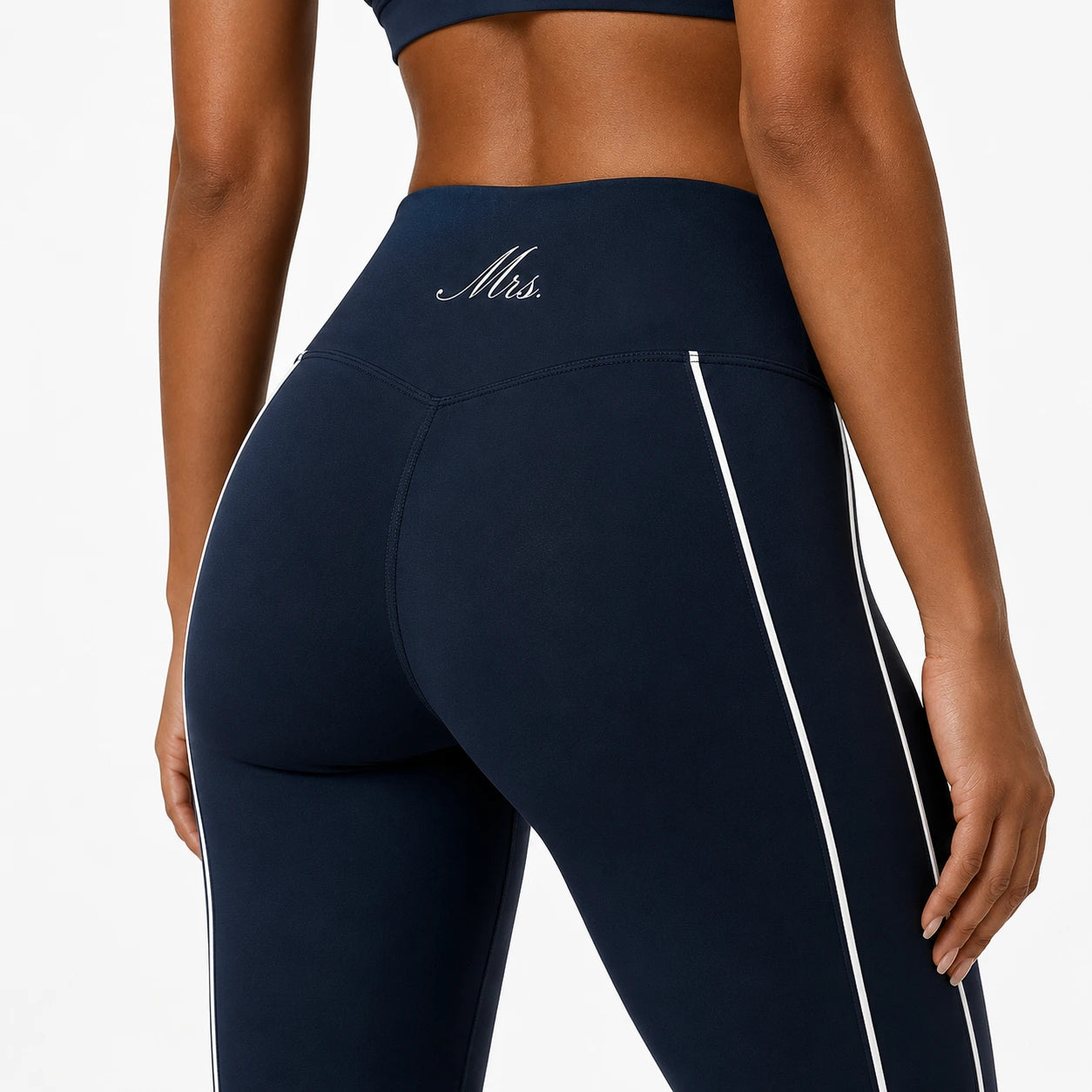Navy blue 'Mrs.' leggings with a white stripe on a plain background