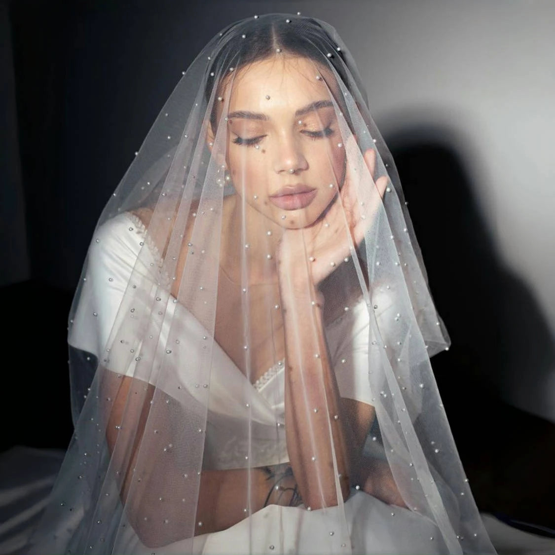 Close-up of bride wearing the Pearl Dream Bridal Veil with delicate pearl-style details over soft tulle.