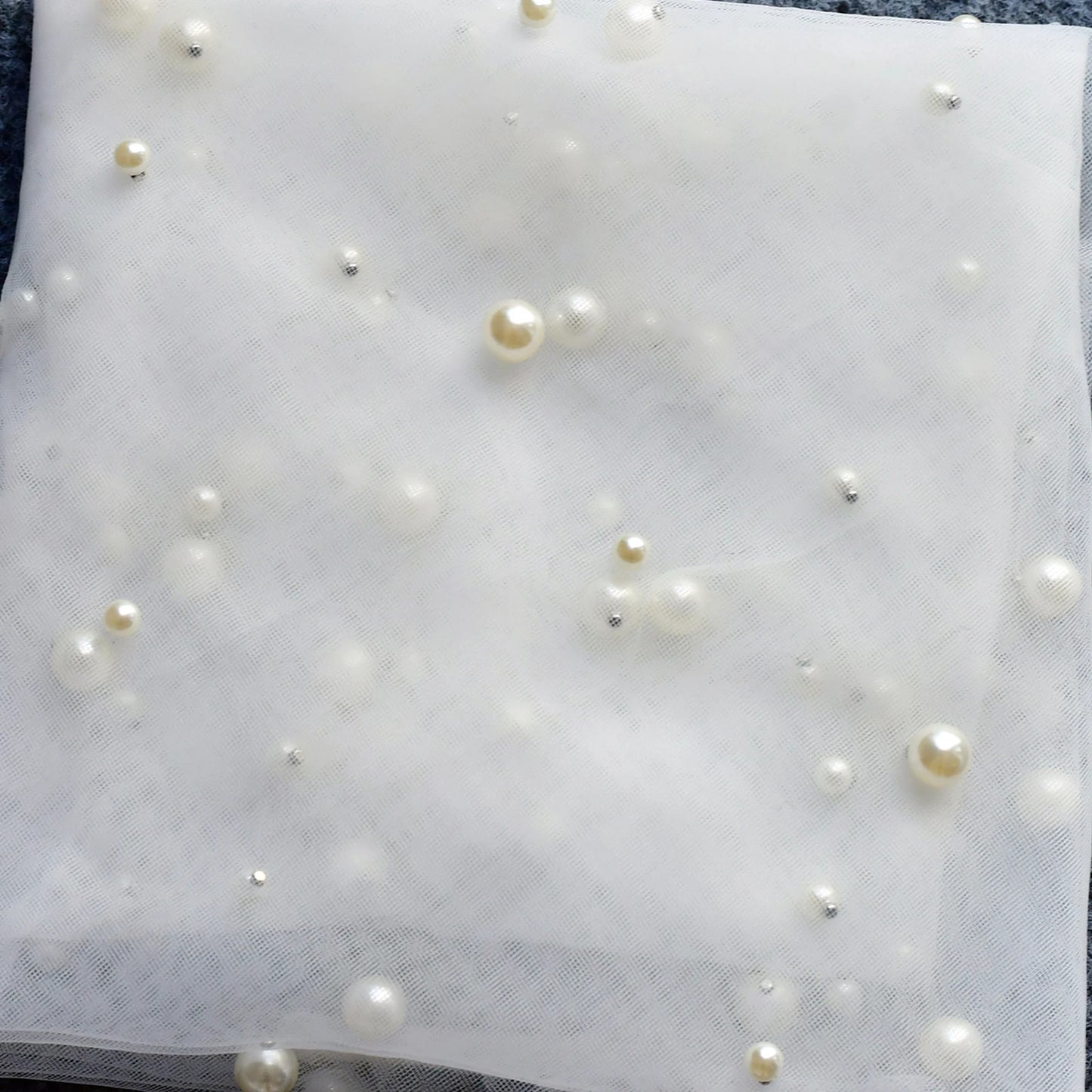 Close-up detail of pearl-dotted ivory tulle on the Pearl Dream Bridal Veil.